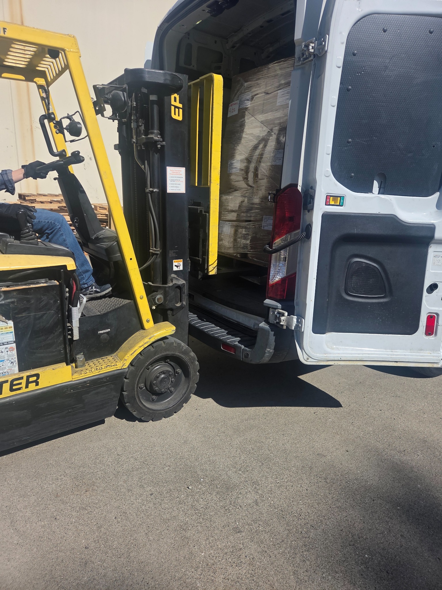 Produce pallets being loaded into Goldmark cargo van